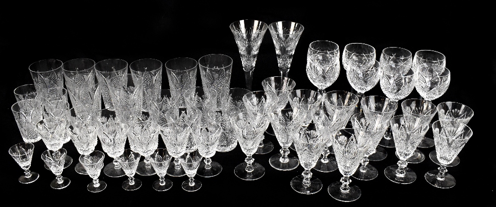 A collection of assorted cut glassware to include two large Waterford wine glasses, beakers, hock