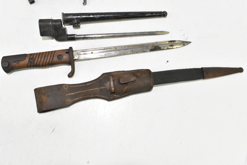 Four bayonets including two German and a socket example, two with scabbards and frogs, the two - Image 2 of 6