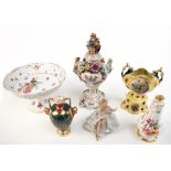 A collection of decorative ceramics and figures with floral and cherub decorated bowls including a