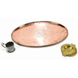 HUGH WALLACE; an Arts & Crafts oval copper tray, engraved with a central fruiting vine motif,