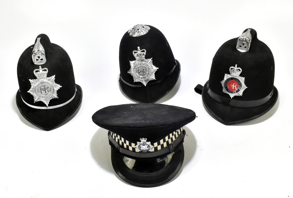 Three Police helmets with Staybrite badges and mounts, the first for Greater Manchester Police by