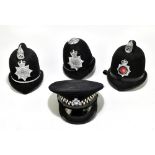 Three Police helmets with Staybrite badges and mounts, the first for Greater Manchester Police by