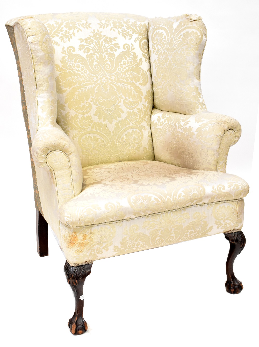 A 19th century mahogany wing back armchair upholstered in a cream sateen fabric,