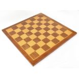 A wooden chessboard, 45 x 45cm.