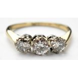 An 18ct gold three stone diamond ring, the central claw set diamond approx 0.