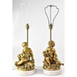 A pair of table lamps in the form of putti, each seated, one amongst grapes, the other wheatsheaves,