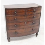 A George III mahogany bow-fronted chest of two short over three long graduated drawers with turned