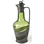 An Art Nouveau green glass claret jug in a pewter mount with grape and vine decoration, height 30cm.