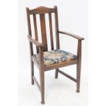 A late 19th/early 20th century oak open elbow dining chair with rail back and upholstered seat,