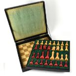 A Staunton Phenolic red and cream resin chess set in fitted case, with double sided board,