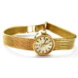 A ladies' Tissot 9ct gold wristwatch, the round silvered dial set with raised baton numerals,