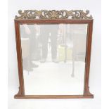 A 19th century mahogany framed overmantel mirror with metal foliate scrolling pediment,