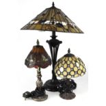 Three non-matching Tiffany-style lamps, an Art Deco style example on column supports,