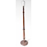 An early/mid-20th century mahogany turned standard lamp to spreading circular base, height 150cm.