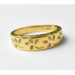 An 18ct yellow gold ring, foliate and floral set with tiny diamonds, size N, approx 3.6g.