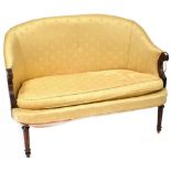 A Victorian mahogany bow-back settee of small proportions, with scroll arms,