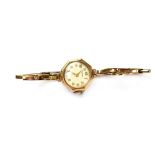 Rotary; a ladies' vintage 9ct gold wristwatch, raised gold numbers on a pale face,
