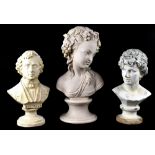 Three decorative plaster busts, one of a young woman in the French style,