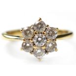 A 14ct gold white stone cluster fashion ring set with seven cubic zirconia stones,