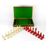 A red and white stained ivory chess set in lockable case, case with vacant cartouche to top.