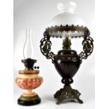 Two early/mid-20th century ceramic oil lamps to include a large brown baluster example with sailing