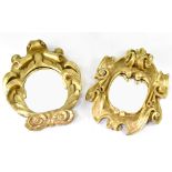 A pair of baroque style gilt framed wall hanging mirrors with scroll and swag decoration,
