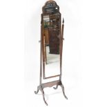 A Georgian-style mahogany cheval mirror with an arched top, on square supports with outswept legs,