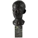 An early 20th century black and bronzed painted plaster bust depicting the head of a young boy