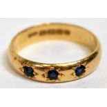 A 22ct yellow gold and three stone sapphire ring, size K, approx 3.5g.