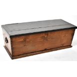 A 19th century blanket box with painted plank top and iron drop handles, on a plinth base,