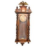 A late 19th/early 20th century Vienna-style mahogany cased wall clock with eagle finial,