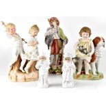 A group of 19th century bisque figures to include a young boy and girl playing, height 34cm,