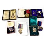 Four hallmarked silver Masonic medals and a locket,