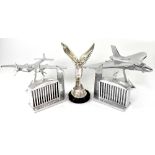 A pair of white metal bookends in the form of a Rolls-Royce car grille with 'Spirit of Ecstasy' to