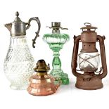 Two decorative oil lamps, one green glass example and one small pink glass example,