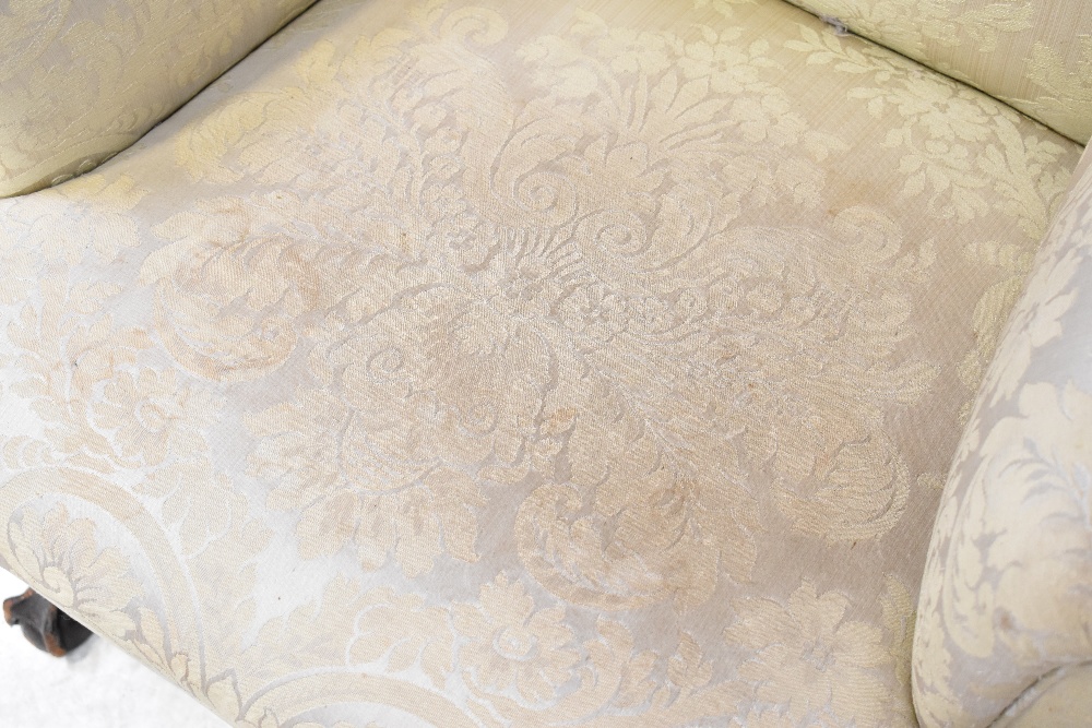 A 19th century mahogany wing back armchair upholstered in a cream sateen fabric, - Image 5 of 6