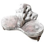 An Edwardian walnut three-seat conversation seat, button back upholstered in grey velour,