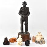 A decorative bronzed figure of a Japanese soldier, a seated figure of laughing Buddha,