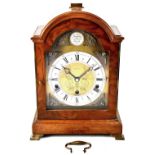 A Georgian-style walnut mantel clock by Syke & Son,