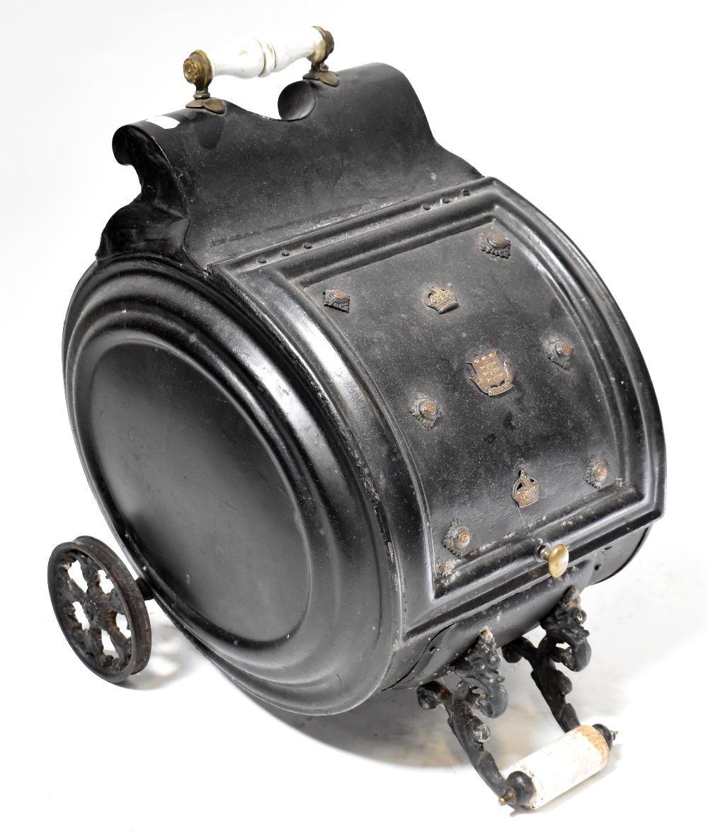 A Victorian metal barrel-form coal scuttle with applied military badges,