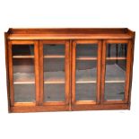 A Victorian mahogany floorstanding bookcase with two pairs of glazed cupboard doors enclosing three