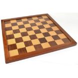 A wooden chessboard, 61 x 61cm.