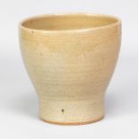 PAUL BARRON (1917-1983); a deep stoneware bowl covered in straw coloured glaze, impressed B mark,