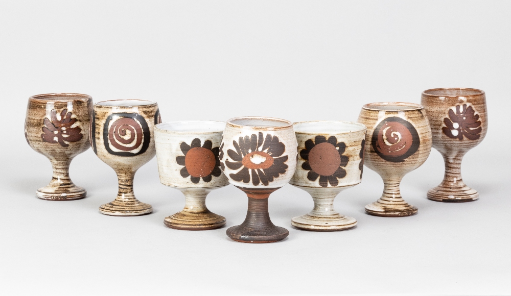 Briglin Pottery; seven tin glazed earthenware goblets with four different decorations, impressed