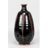 CHARLES VYSE (1882-1971); a tall stoneware bottle covered in tenmoku glaze with copper pours,
