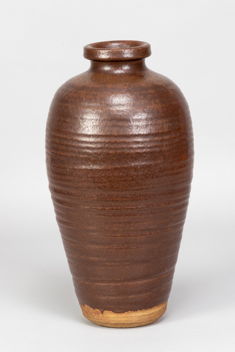 WILLIAM STAITE MURRAY (1881-1962); a tall stoneware bottle covered in iron rich glaze, impressed M