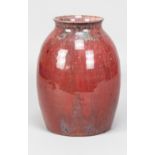 Ruskin Pottery; a high fired stoneware vase covered in mottled sang de boeuf glaze, impressed