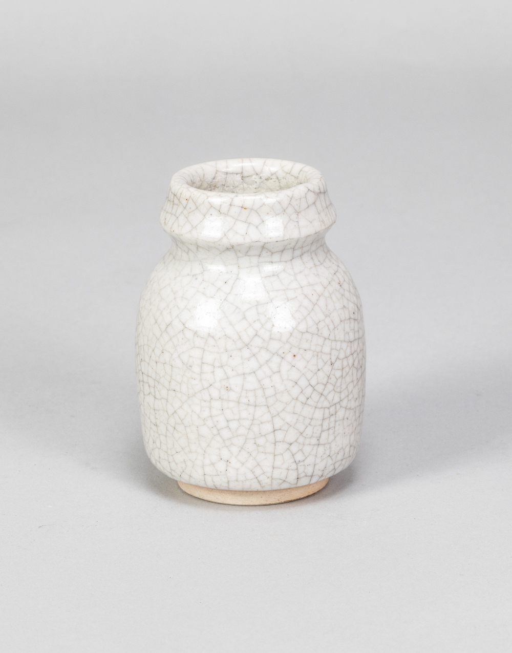 CONSTANCE DUNN; a small stoneware vase covered in white crackle glaze, impressed W mark, made