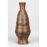 ROBERT J WASHINGTON (1913-1997); a tall stoneware bottle covered in iron rich glaze and painted