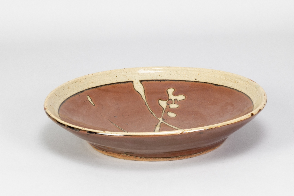 SHOJI HAMADA (1894-1978); a large stoneware plate with wax resist broken sugar cane decoration on